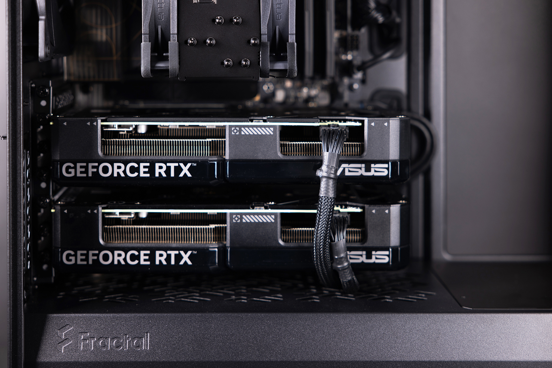 Close-up of a Chillblast workstation interior showing dual ASUS GeForce RTX graphics cards installed inside a Fractal case, with visible cooling and cabling.