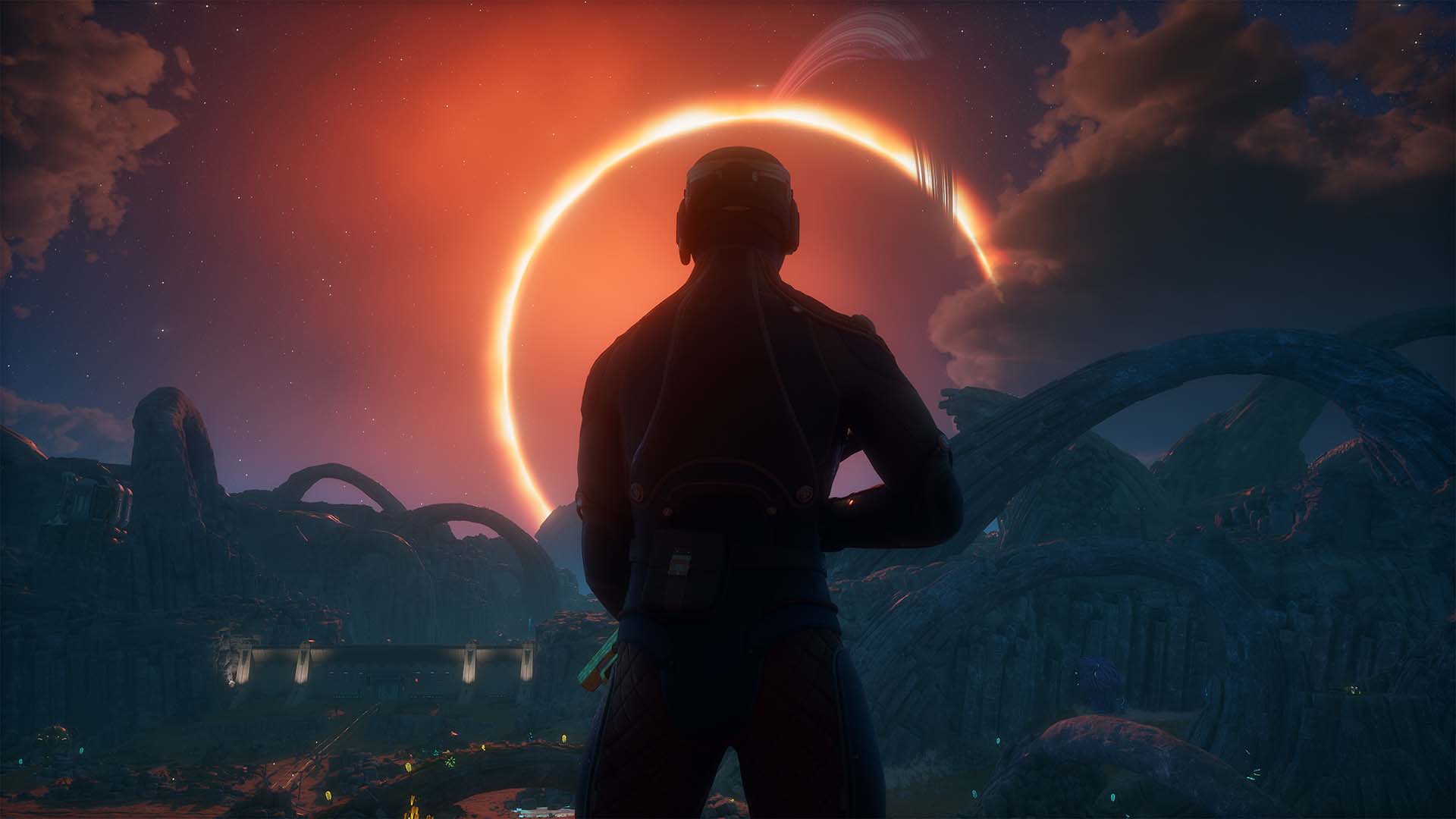 A character in a spacesuit stands on an alien landscape watching a glowing eclipse over distant mountains in The Outer Worlds 2.
