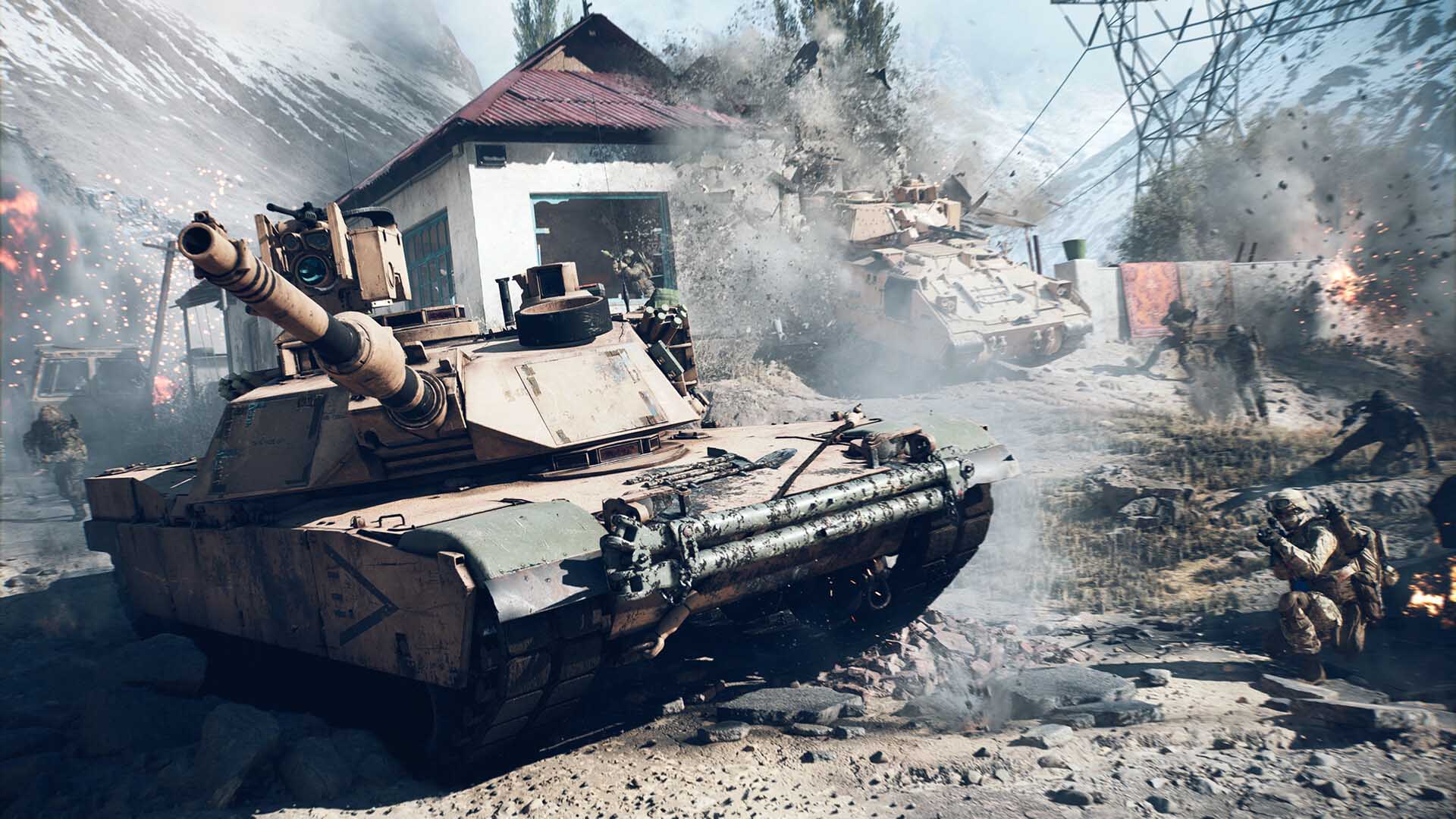 A battlefield scene with two military tanks moving through a war-torn village as explosions erupt around them. Soldiers take cover and engage in combat amidst debris and destruction.