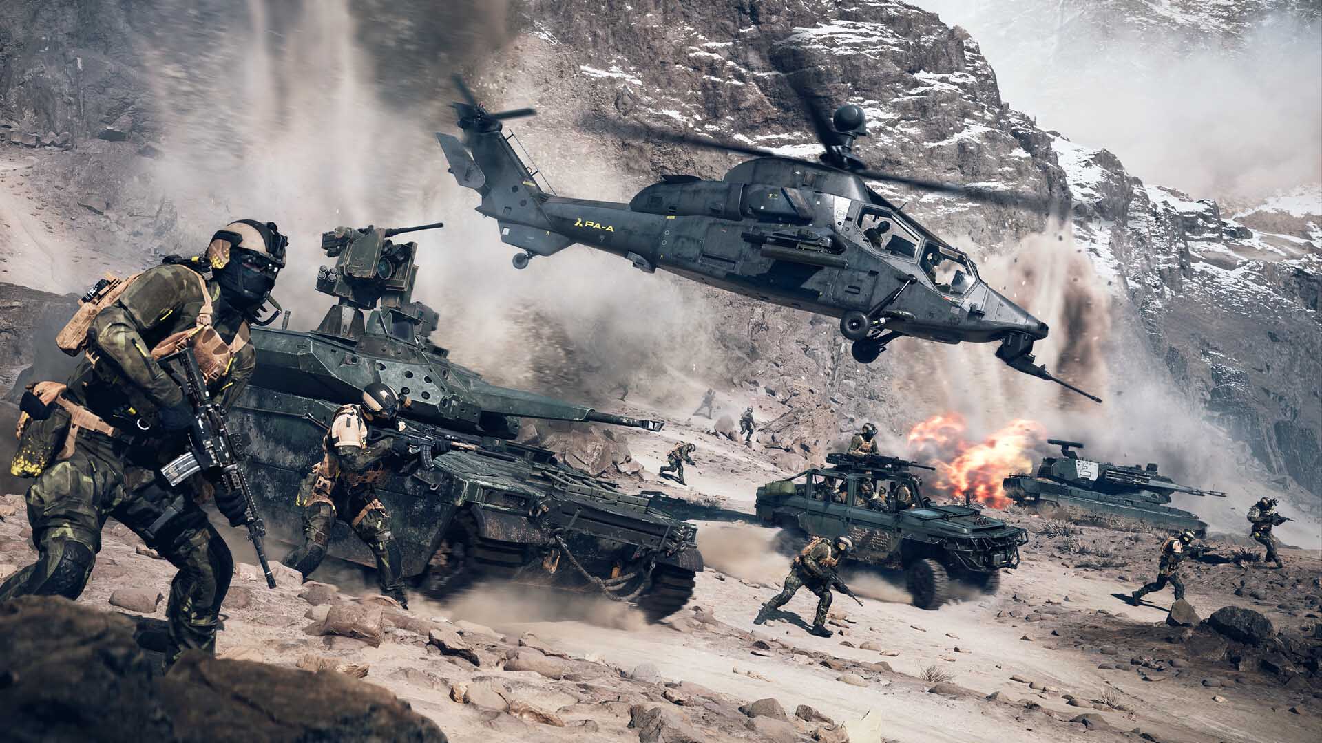 Intense desert combat scene featuring soldiers advancing alongside tanks, a military helicopter hovering mid-air, and explosions erupting in the background.