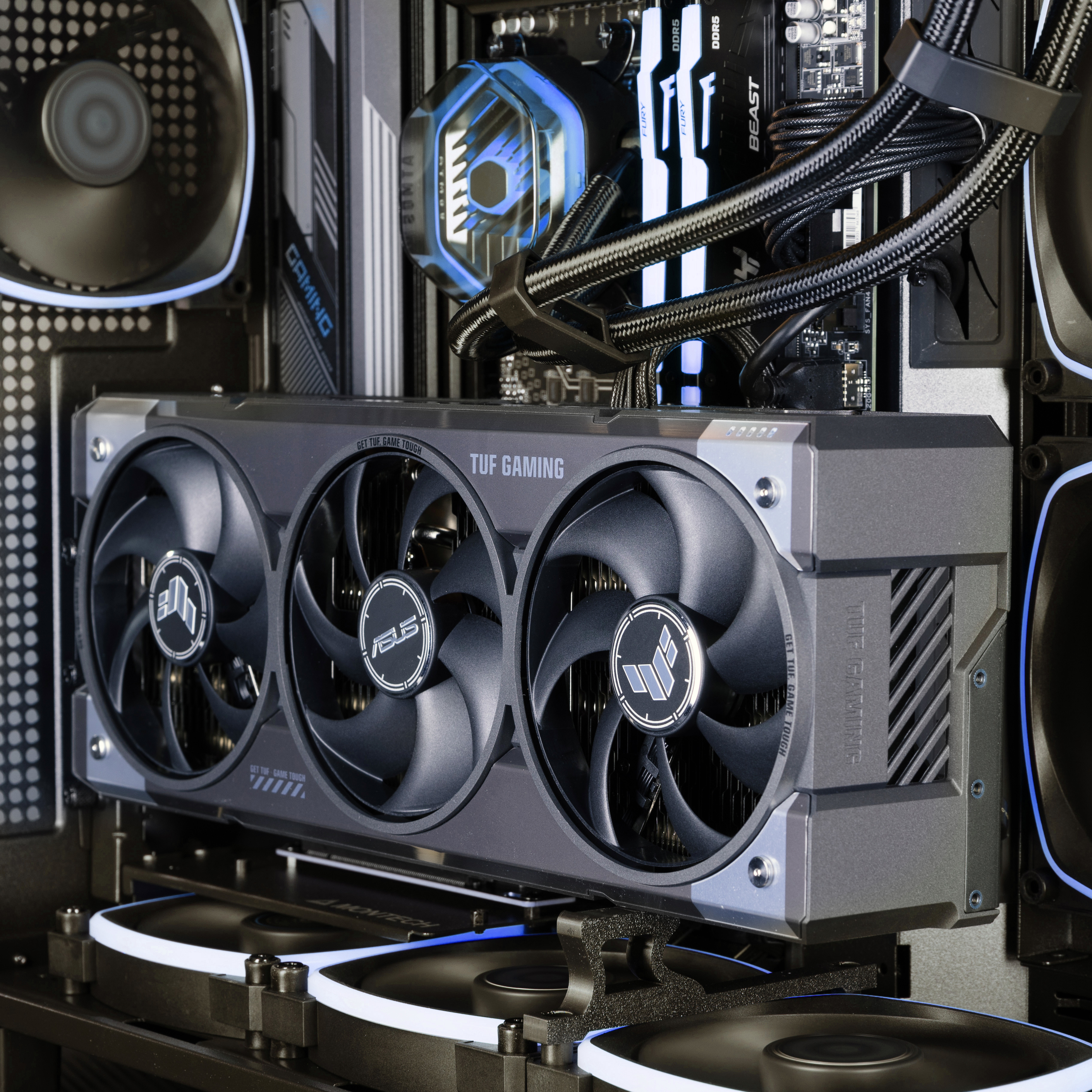 Looking in to the PC from the side, showing the GeForce RTX 5080 graphics card bathed in blue from the RGB
