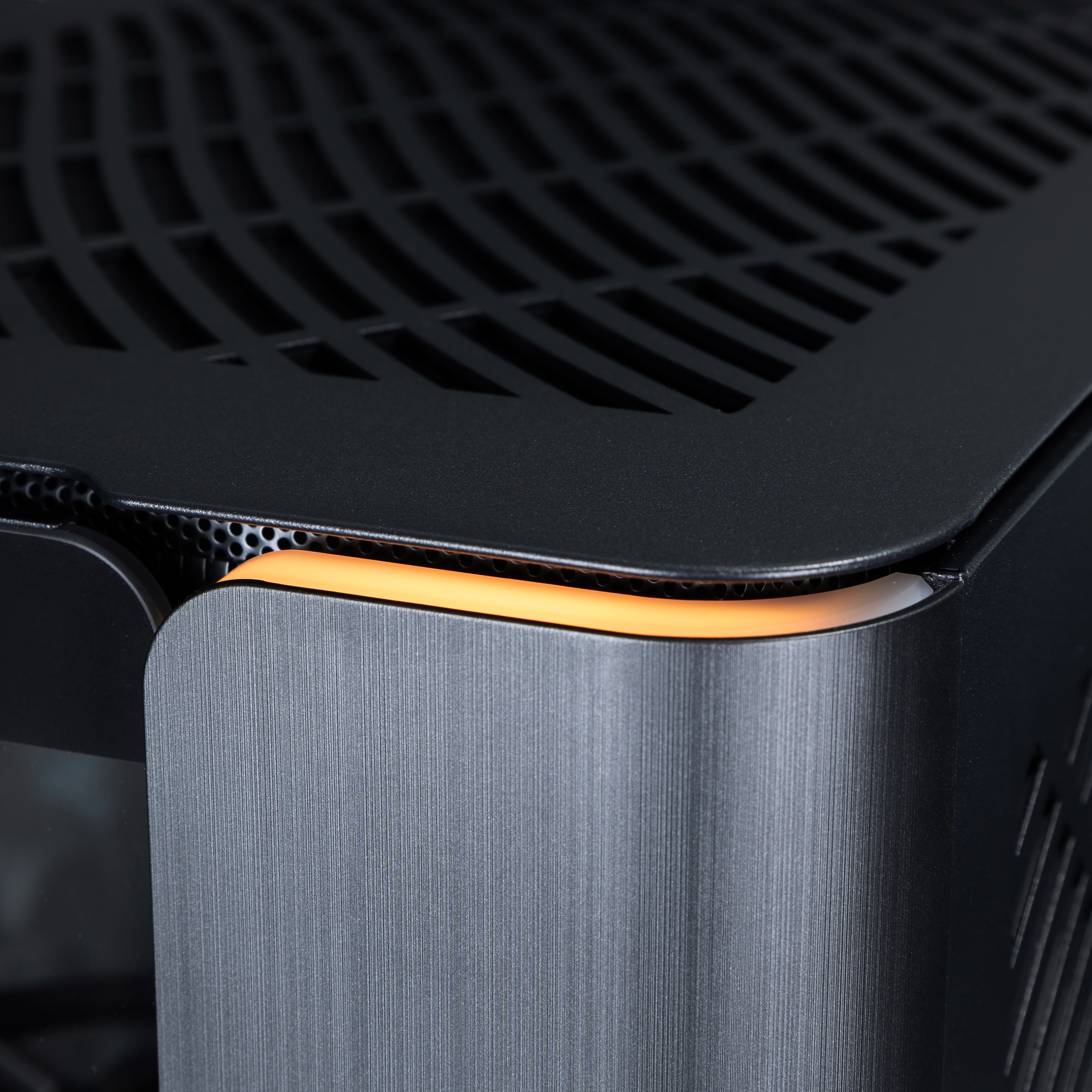 A view of the front corner of the case, showing the clean lines and mellow yellow RGB lighting