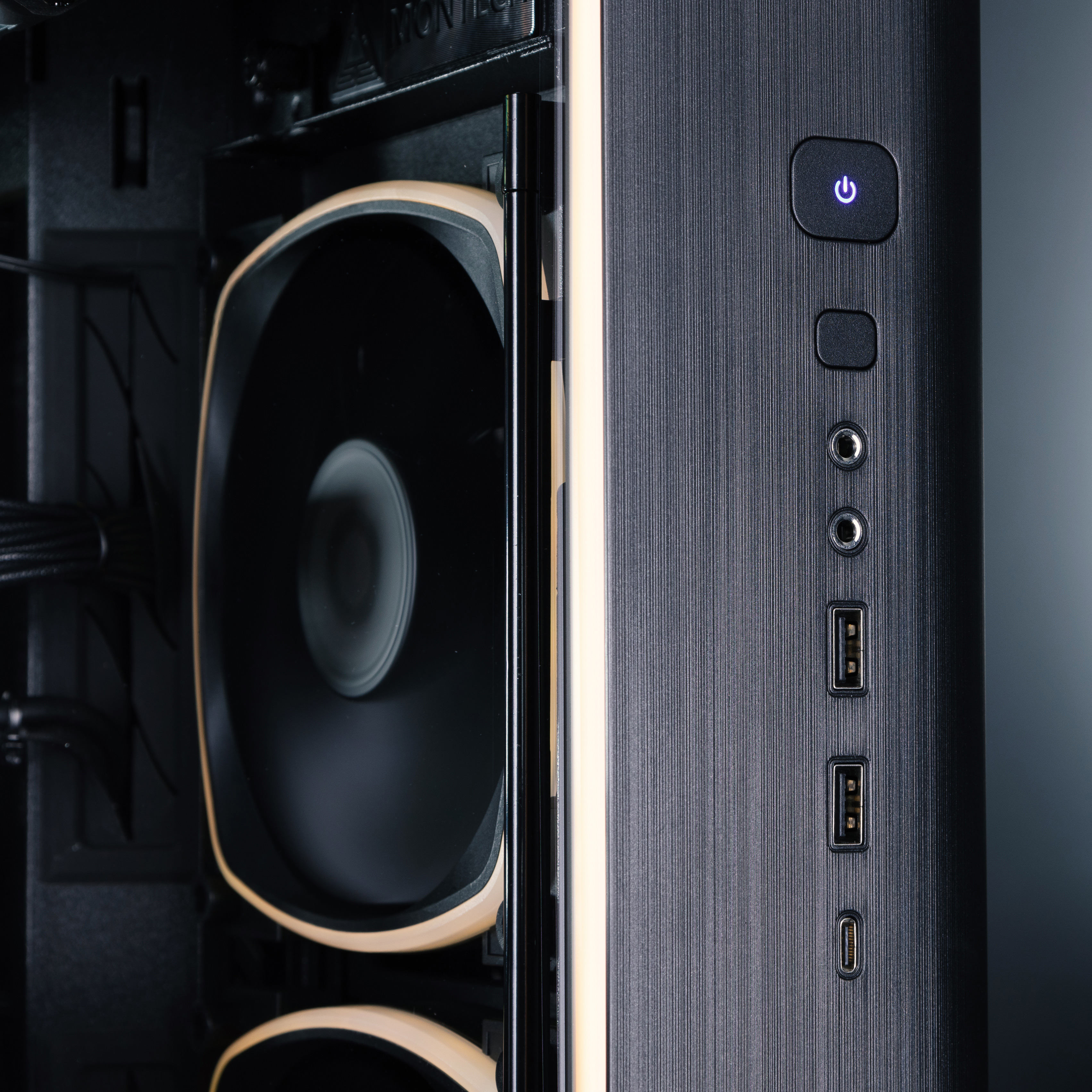 The front I/O panel of the Forge 5090 gaming PC, with a view of the internal fans