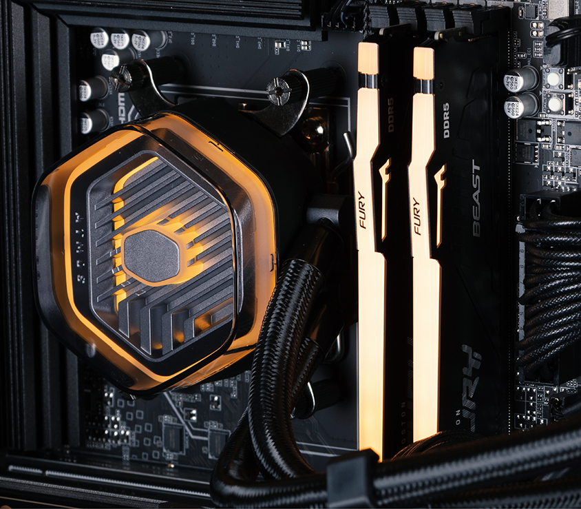 A close up of the CPU cooler and RGB memory, bathed in a yellow glow