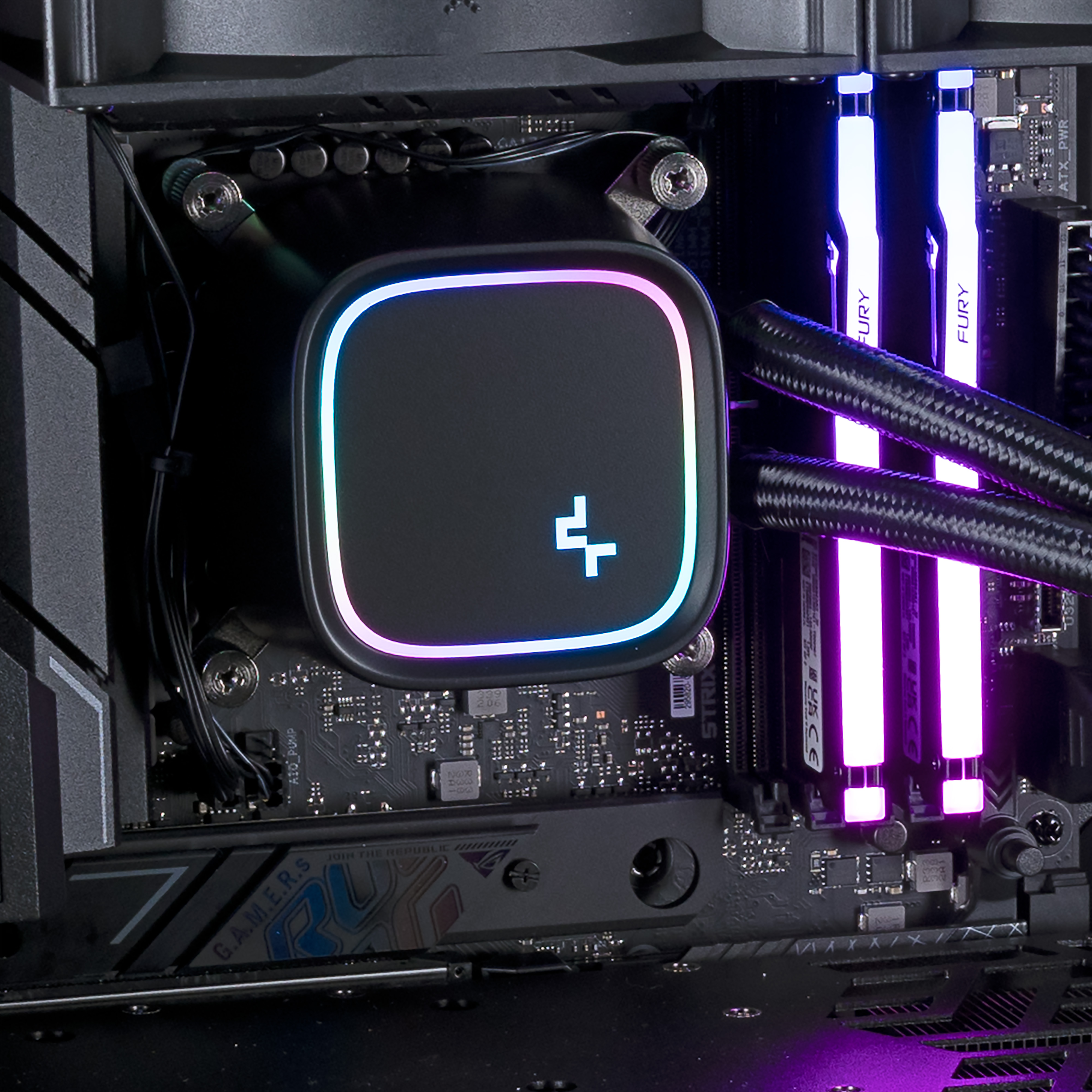A B550 motherboard with some RAM and a CPU cooler block installed