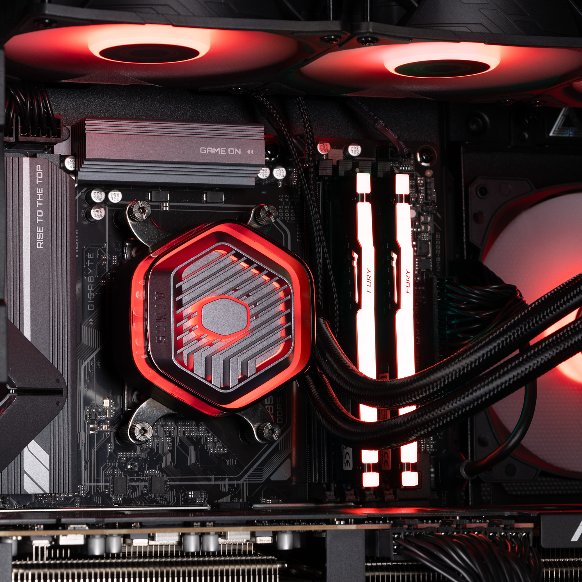 The CPU cooler block installed with the radiator fans above, all glowing red