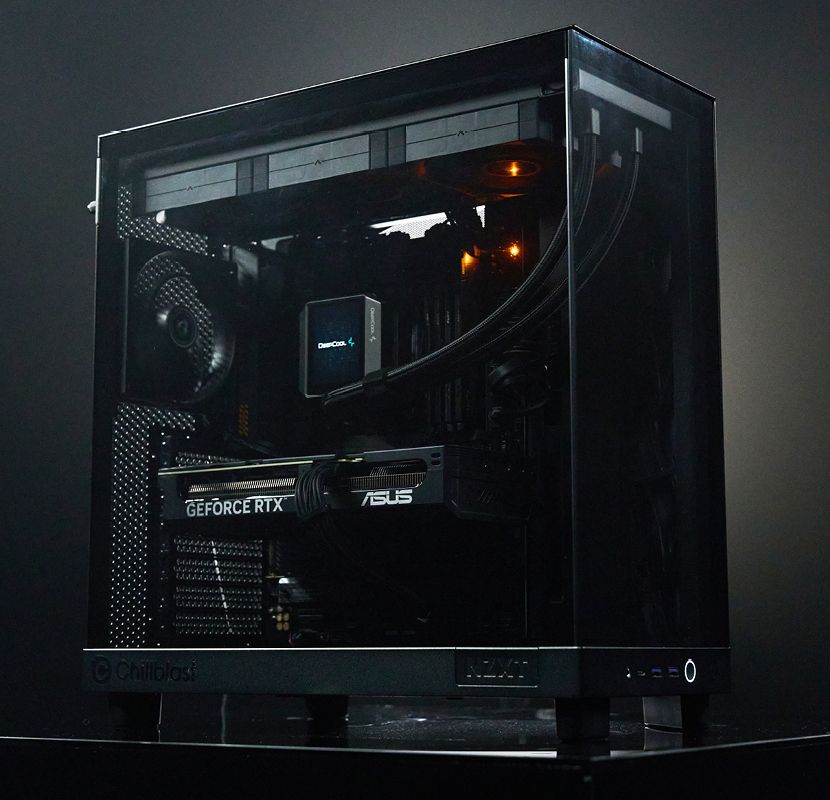 Chillblast Onyx PC from the Origin range, featuring a sleek black chassis with a tempered glass side panel, showcasing an ASUS GeForce RTX graphics card, a DeepCool liquid cooling system, and meticulously arranged internal components, illuminated with subtle orange lighting.