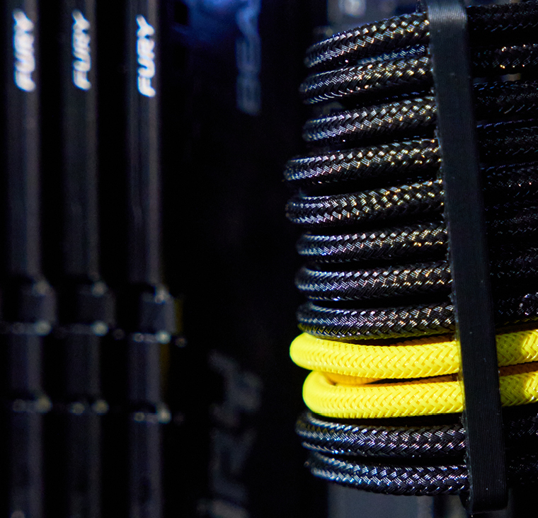 Close-up of internal PC components, featuring Kingston Fury RAM sticks, a neatly coiled black-and-yellow custom cable, and a digital display with glowing numbers, highlighting premium build quality and attention to detail.