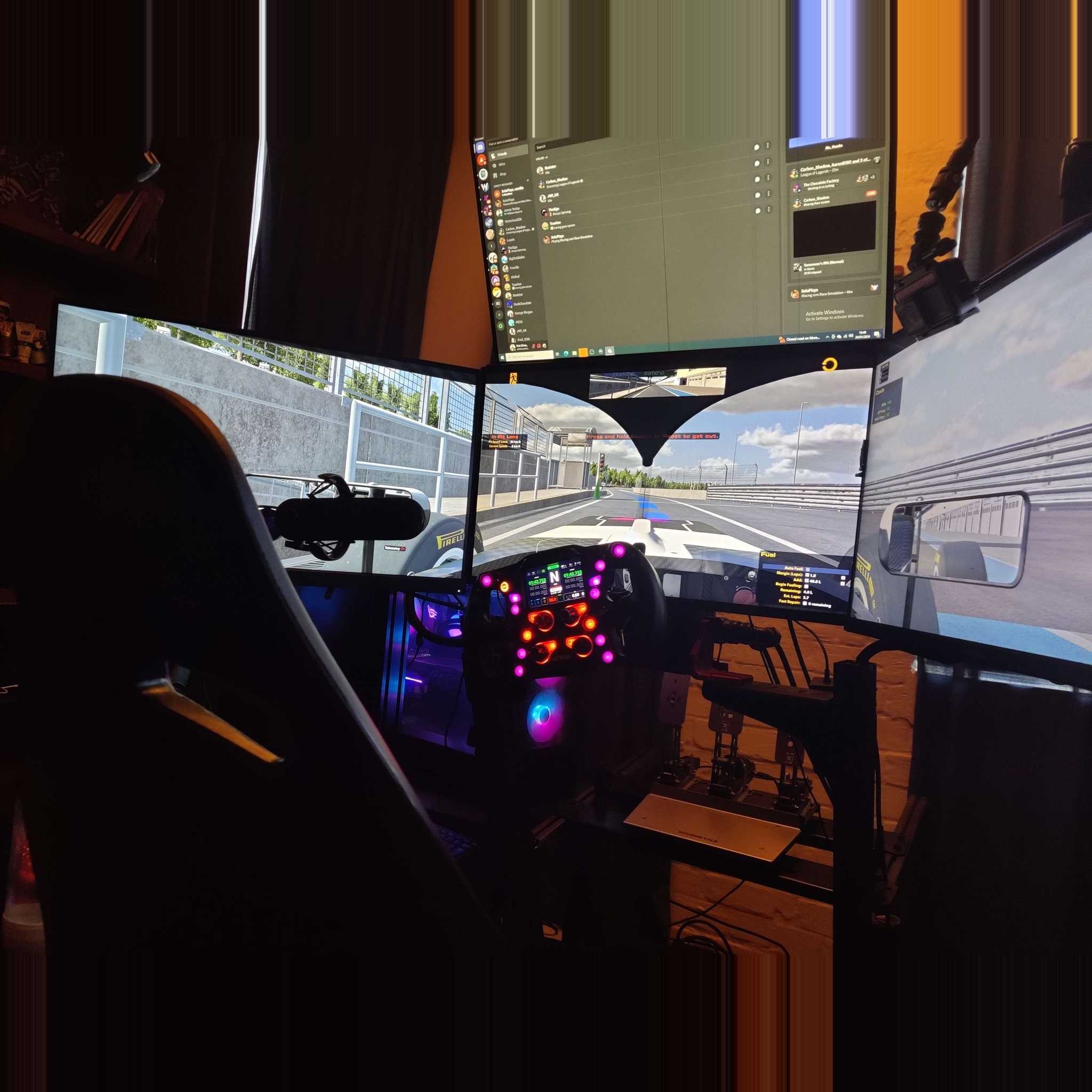 3 screen racing simulator with steering wheel and gaming chair set up