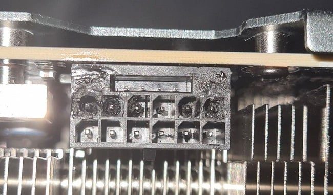 Close up photo of a slightly melted and damaged RTX 4090 GPU connector port